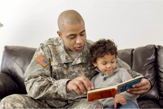 Veteran reading book to a child.